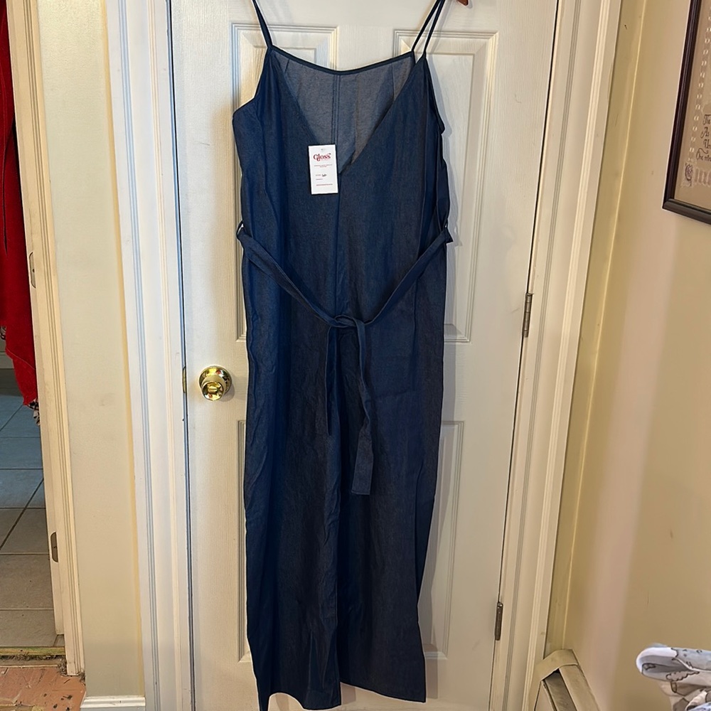 New with tags, light denim jumper with tie waste.